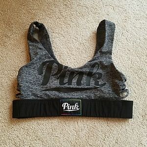 Small pink brand sports bra in black and gray